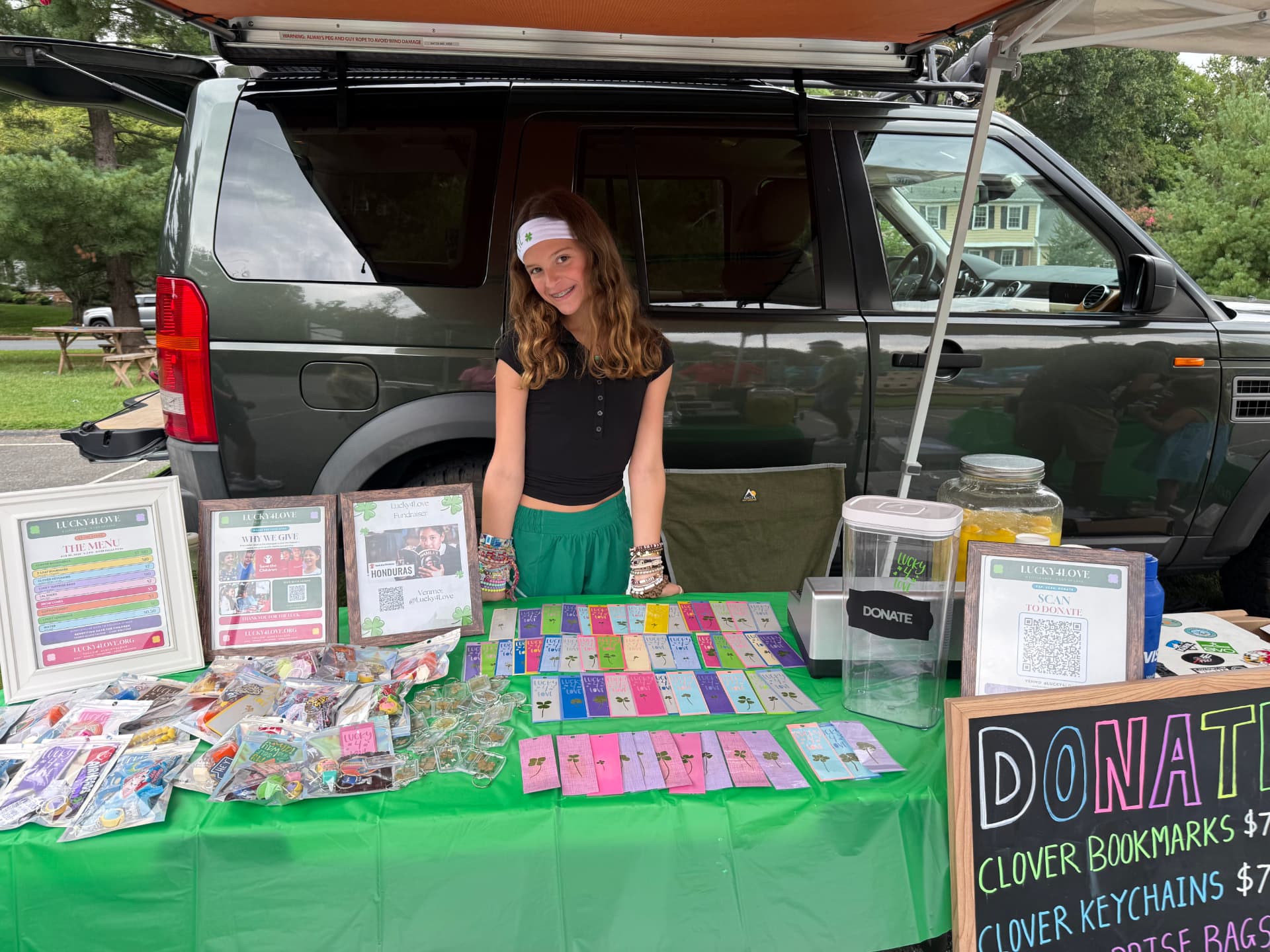 Henley at the Lucky4Love table with clover bookmarks and keychains
