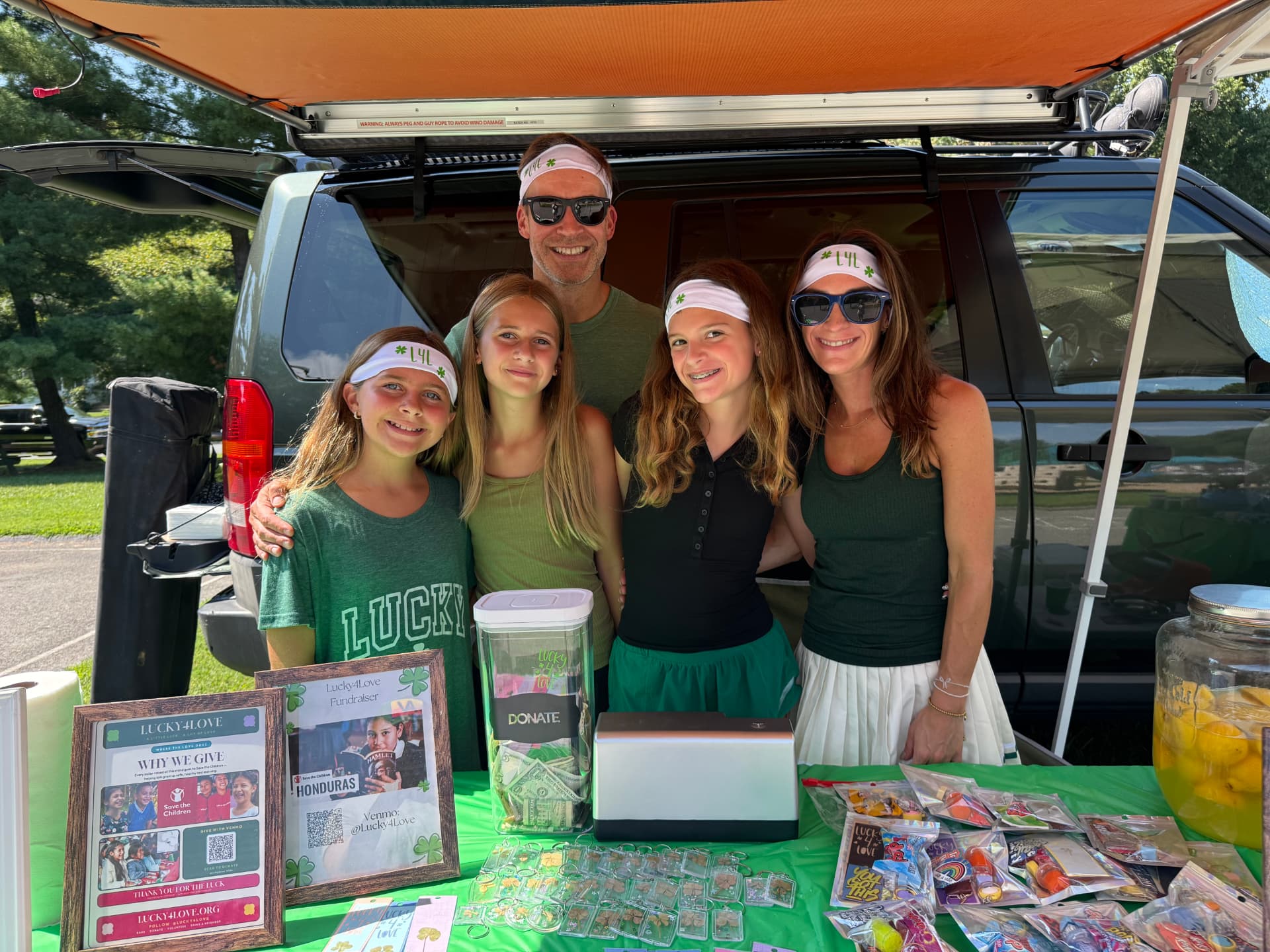 The Lucky4Love family behind the fundraising table at River Falls Pool