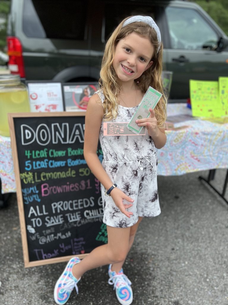 Henley smiling at the Lucky4Love donation stand