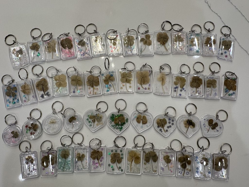 Rows of clear clover keychains with real four-leaf clovers inside