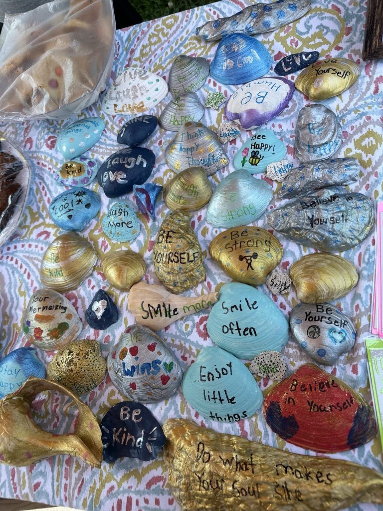 Hand-painted kindness rocks with messages like Be Kind and Smile Often